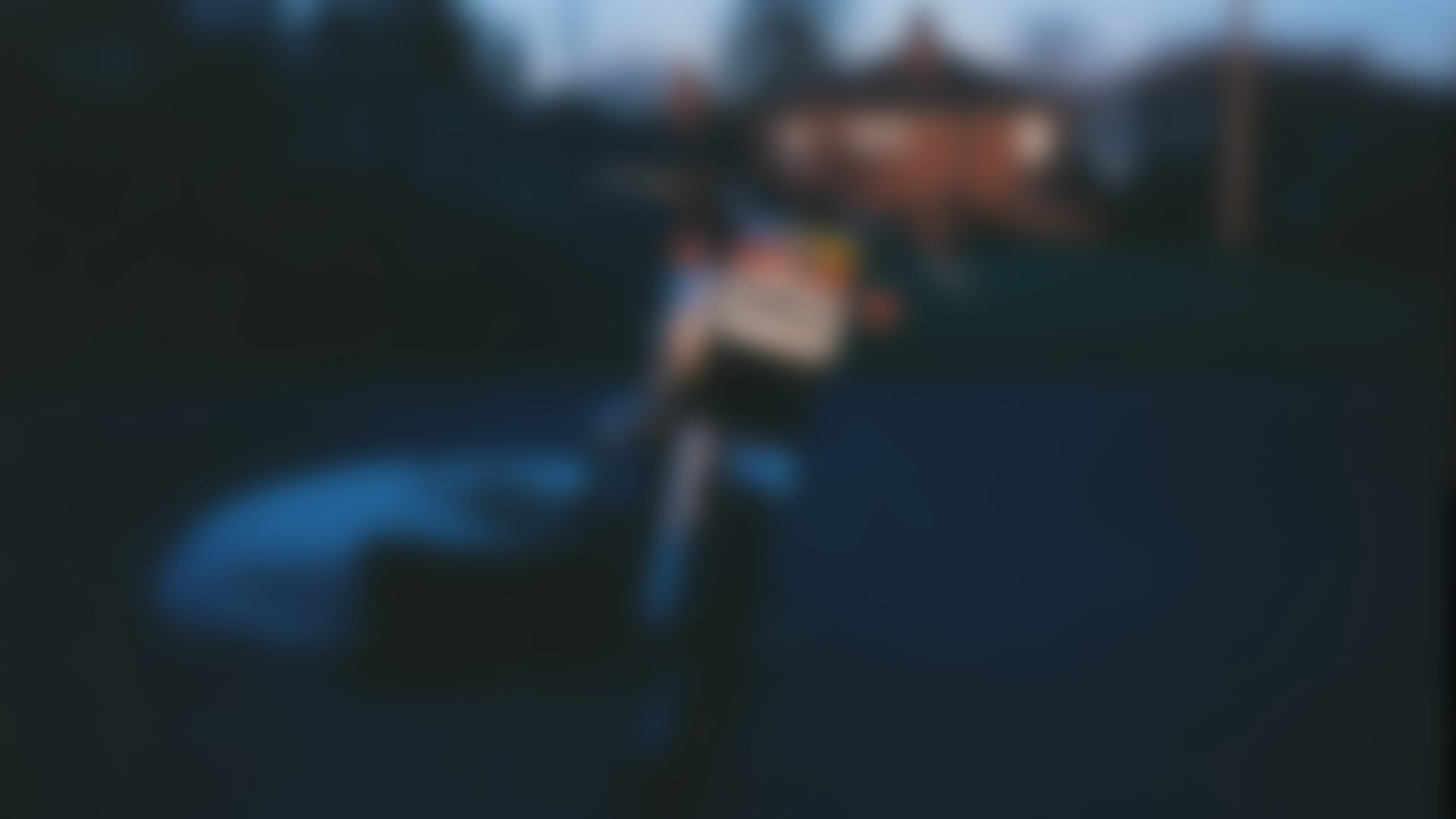 A motorcycle parked on a suburban driveway in early morning light, with a folded bike cover on the ground beside it.